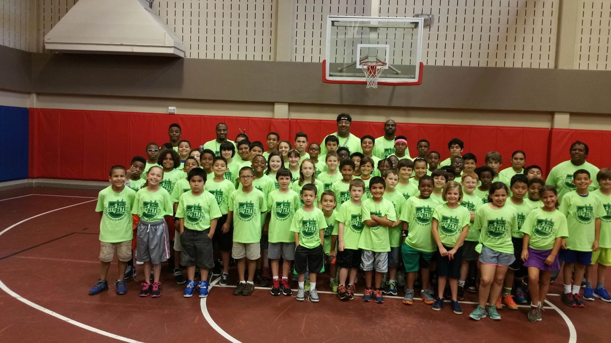 Large group in neon green shirts on basketball court