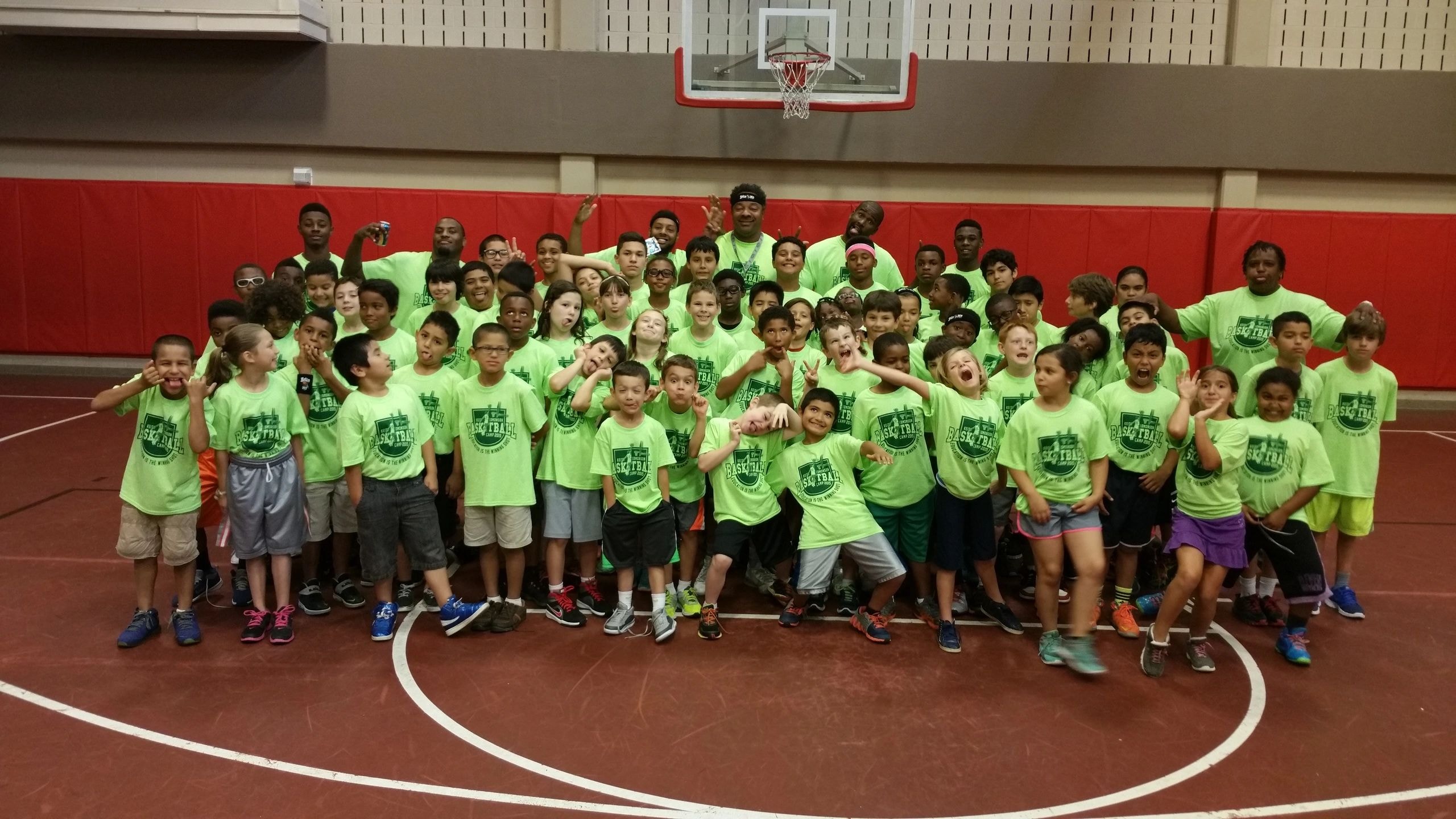 Children and adult mentor in gymnasium